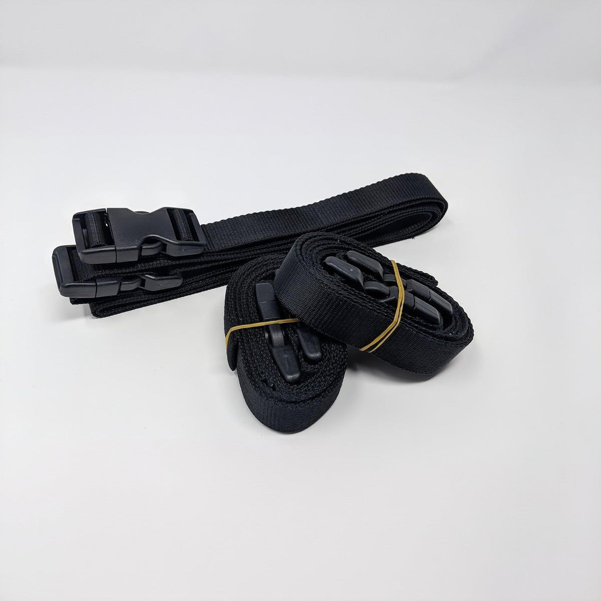 The extra strap set included with the Weatherproof Shield: black straps with side-release buckles