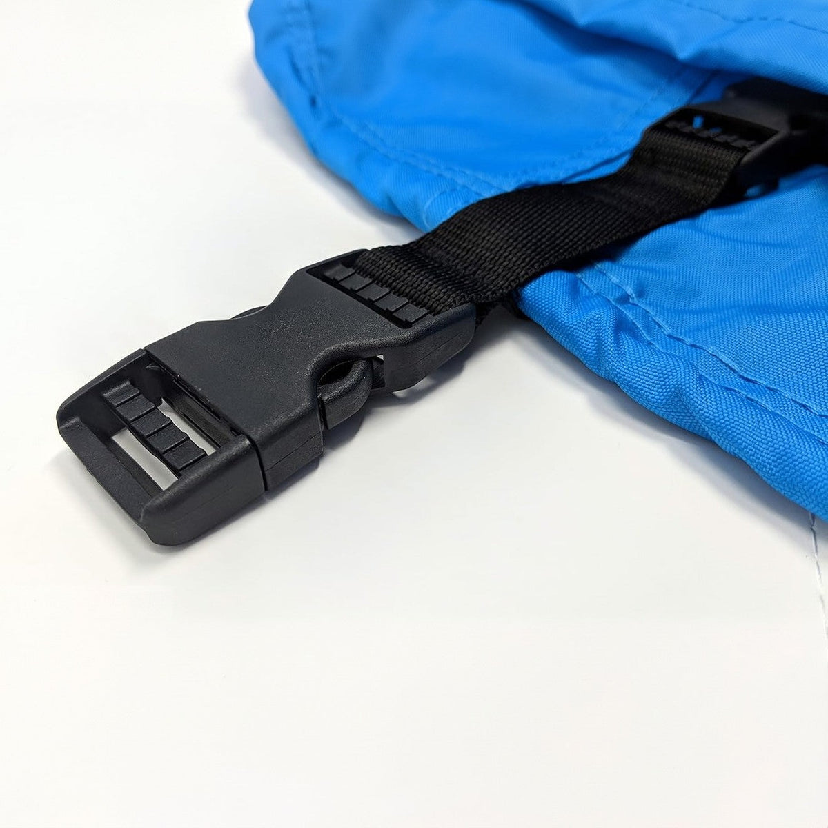 Close-up of a built-in side-release buckle and strap on a blue cover